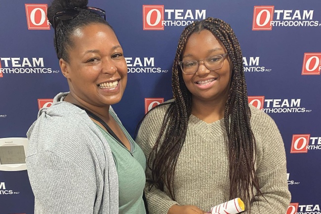 Mother and daughter patients of Team Orthodontics smile for a photo.