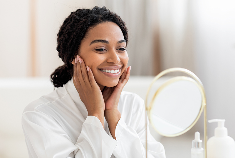 Woman loving her new smile in the mirror