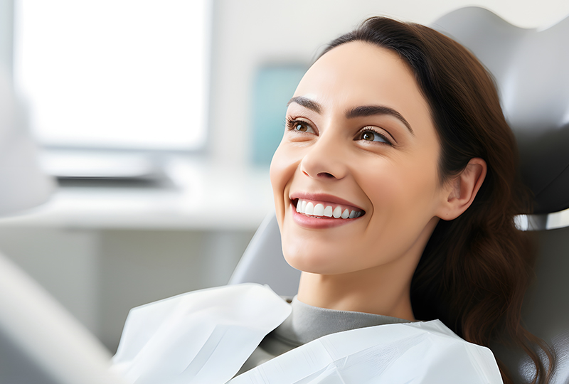 Younger woman smiling at the dental office with beautiful white teeth