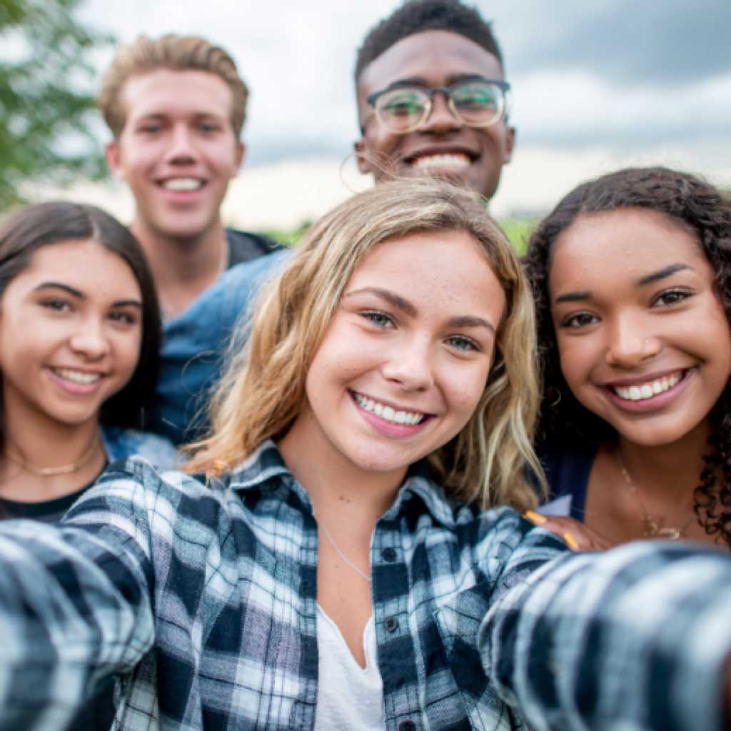 Smiling young adults showing confident smiles after orthodontic treatment at Team Orthodontics.