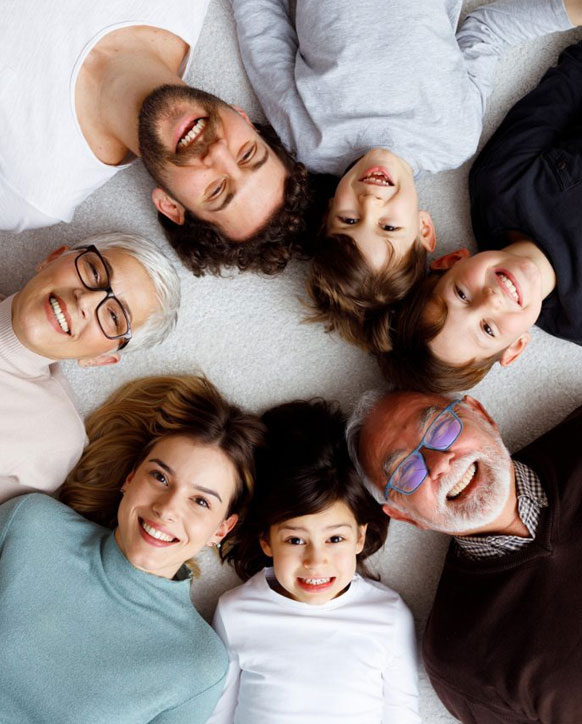 Happy family smiling together with bright, healthy smiles after professional Zoom Whitening treatment.