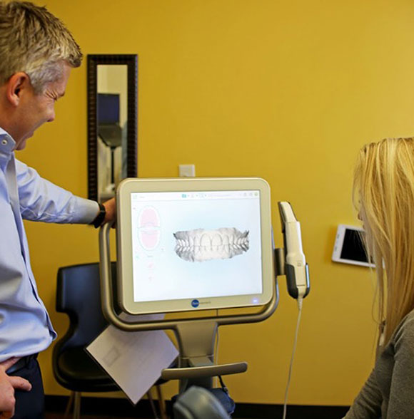 Orthodontist explaining a child's treatment plan during a two-phase orthodontic consultation.