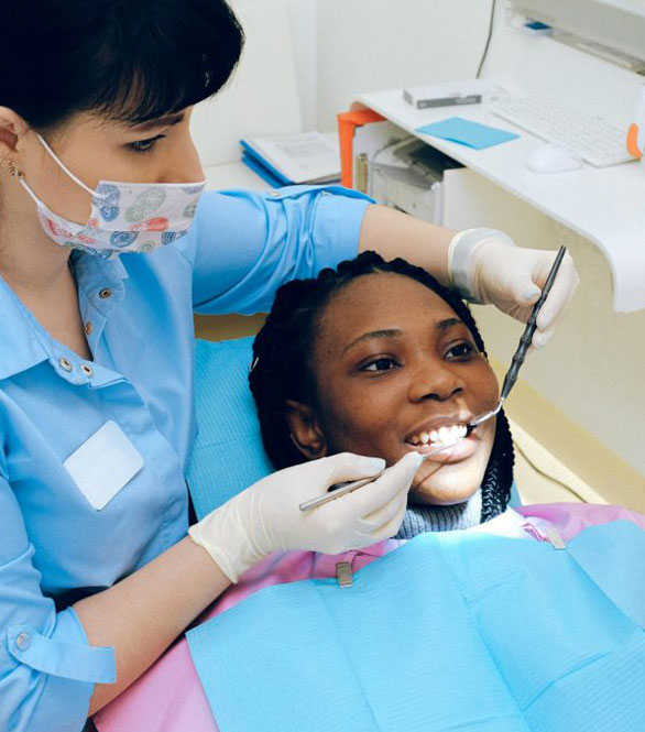 Orthodontist providing a comprehensive TMJ and TMD evaluation for a patient at Team Orthodontics.