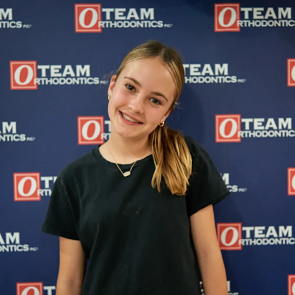 Young orthodontic patient smiling after beginning two-phase orthodontic treatment at Team Orthodontics.